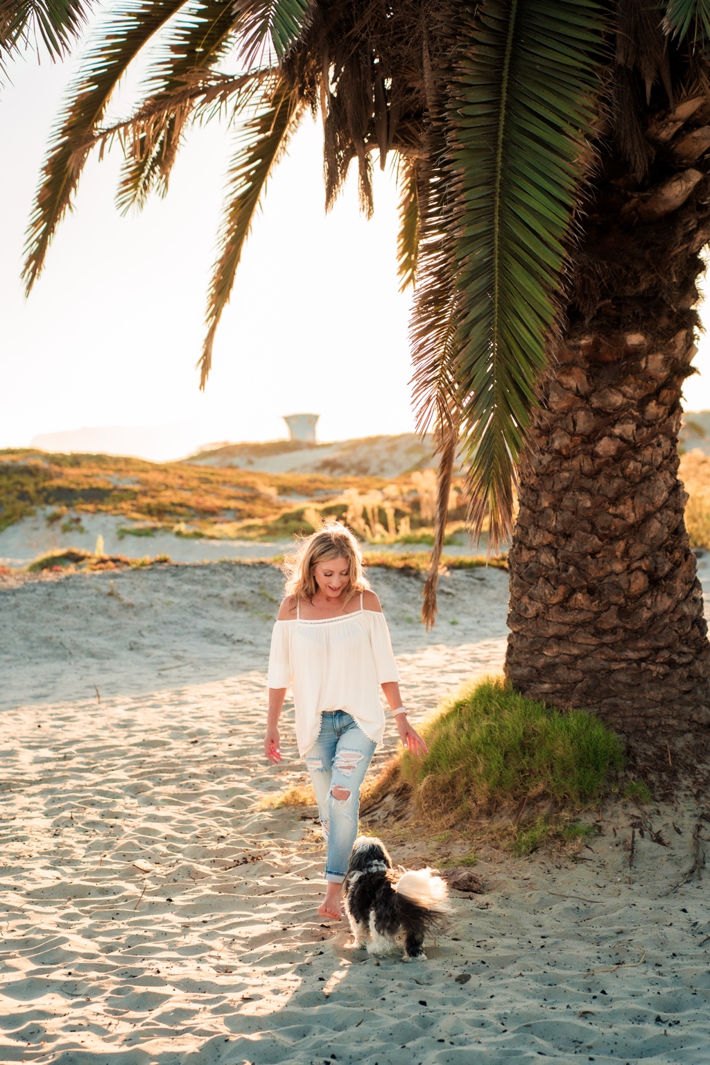 Candice and Basil enjoying a relaxed walk beneath a palm tree